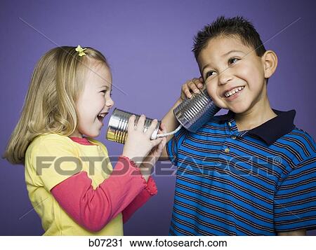 Little girl and boy with tin cans and string View Large Photo Image Stock Image - Little girl and boy with tin cans and string. Fotosearch