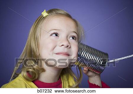 Little girl listening into tin can with string View Large Photo Image Stock Image - Little girl listening into tin can with string. Fotosearch