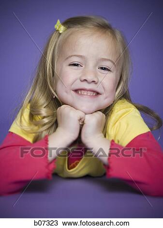 Little girl smiling with chin on hands View Large Photo Image Stock Image - Little girl smiling with chin on hands. Fotosearch