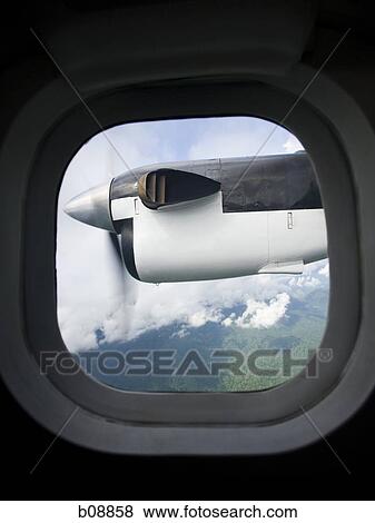 Looking out the window of an airplane View Large Photo Image Stock Photo - Looking out the window of an airplane. Fotosearch