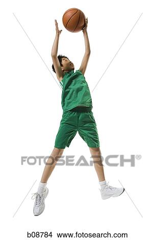 Low angle view of a boy jumping and throwing a basketball View Large Photo Image Picture - Low angle view of a boy jumping and throwing a basketball. Fotosearch