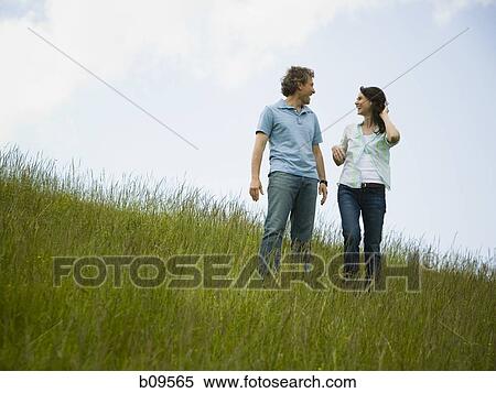 Stock Photography - Low angle view of a man and a woman looking at each other. Fotosearch