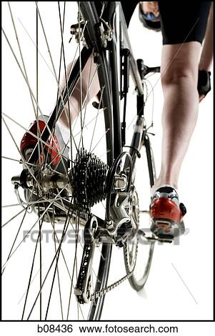 Low angle view of a man cycling View Large Photo Image Stock Photograph - Low angle view of a man cycling. Fotosearch