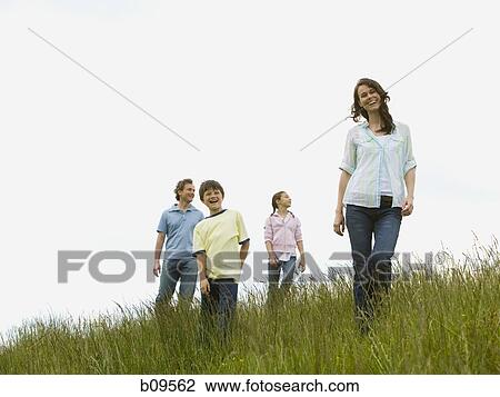 Low angle view of a woman and a man with their son and daughter in a field View Large Photo Image Stock Image - Low angle view of a woman and a man with their son and daughter in a field. Fotosearch