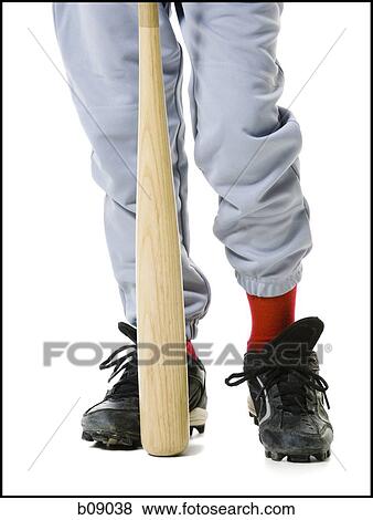 Low section view of a baseball player holding a baseball bat View Large Photo Image Stock Photo - Low section view of a baseball player holding a baseball bat. Fotosearch