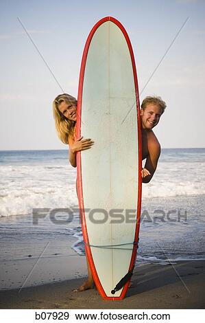 Male and female surfer posing with surfboard View Large Photo Image Stock Photo - Male and female surfer posing with surfboard. Fotosearch