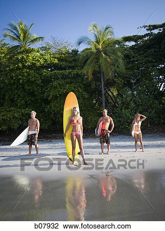 Male and female surfers View Large Photo Image Stock Image - Male and female surfers. Fotosearch