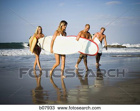 Male and female surfers View Large Photo Image Stock Image - Male and female surfers. Fotosearch
