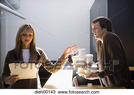 Male office worker fetching coffee View Large Photo Image Stock Image - Male office worker fetching coffee. Fotosearch