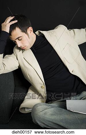 Male office worker napping on chair View Large Photo Image Stock Photo - Male office worker napping on chair. Fotosearch