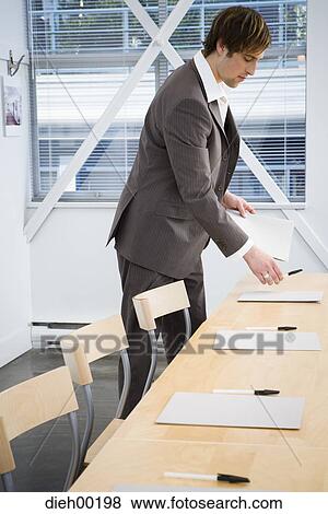 Male office worker preparing for meeting View Large Photo Image Stock Photo - Male office worker preparing for meeting. Fotosearch