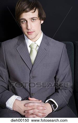 Stock Image - Male office worker sitting and posing. Fotosearch