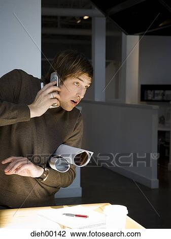 Male office worker talking on phone View Large Photo Image Stock Image - Male office worker talking on phone. Fotosearch