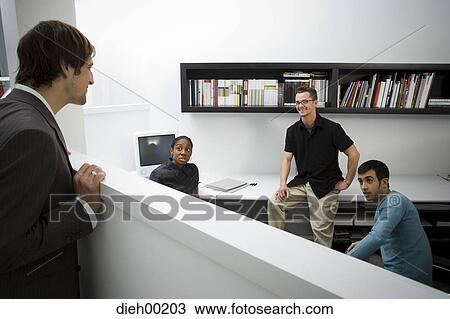 Male office workers talking View Large Photo Image Stock Image - Male office workers talking. Fotosearch