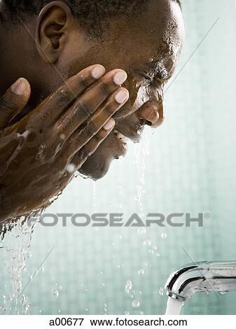 Stock Photo - Male washing his face. Fotosearch