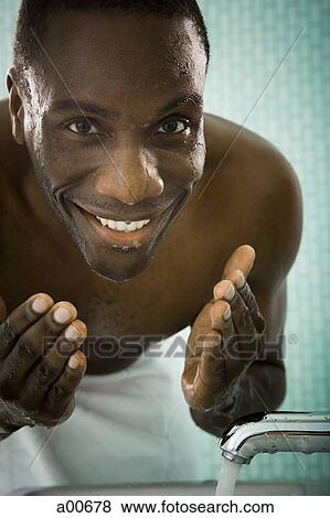 Male washing his face View Large Photo Image Stock Photo - Male washing his face. Fotosearch