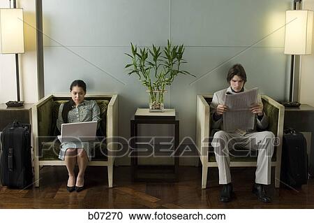 Man and woman in hotel lobby View Large Photo Image Stock Image - Man and woman in hotel lobby. Fotosearch