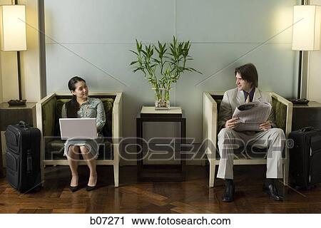 Man and woman in hotel lobby View Large Photo Image Stock Image - Man and woman in hotel lobby. Fotosearch