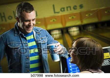 Man and woman talking at bowling alley View Large Photo Image Stock Photo - Man and woman talking at bowling alley. Fotosearch
