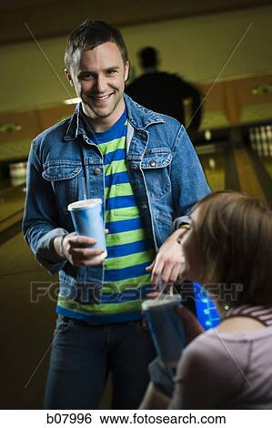 Man and woman talking at bowling alley View Large Photo Image Stock Photograph - Man and woman talking at bowling alley. Fotosearch