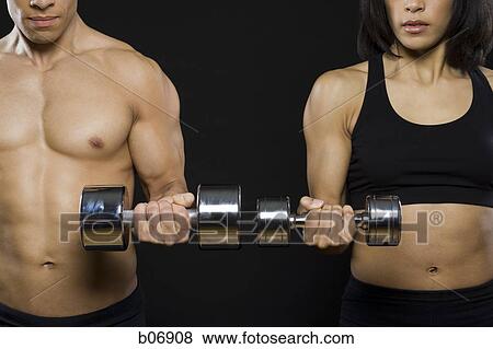 Man and woman working out with dumbells View Large Photo Image Stock Photo - Man and woman working out with dumbells. Fotosearch