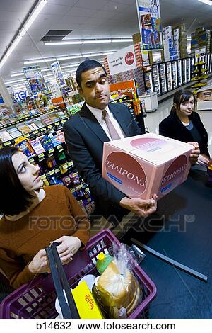 Man at grocery checkout with box of tampons and two women View Large Photo Image Stock Image - Man at grocery checkout with box of tampons and two women. Fotosearch