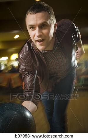 Man bowling in alley View Large Photo Image Stock Image - Man bowling in alley. Fotosearch