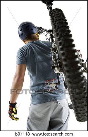 Man carrying mountain bike View Large Photo Image Stock Photo - Man carrying mountain bike. Fotosearch