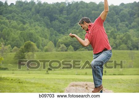 man dancing on a hay bale View Large Photo Image Stock Image - man dancing on a hay bale. Fotosearch