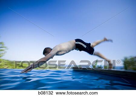 Man diving into infinity pool View Large Photo Image Stock Image - Man diving into infinity pool. Fotosearch
