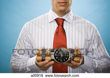 Man holding sticks of dynamite with timing device View Large Photo Image Stock Photo - Man holding sticks of dynamite with timing device. Fotosearch