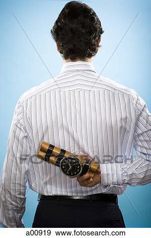Man holding sticks of dynamite with timing device View Large Photo Image Stock Photo - Man holding sticks of dynamite with timing device. Fotosearch