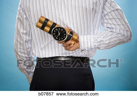 Man holding sticks of dynamite with timing device View Large Photo Image Stock Photo - Man holding sticks of dynamite with timing device. Fotosearch