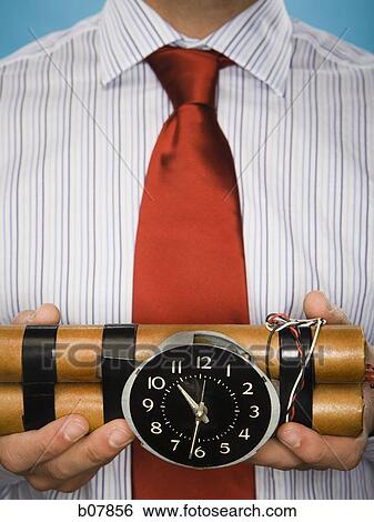 Man Holding Sticks Of Dynamite With Timing Device Stock Photograph