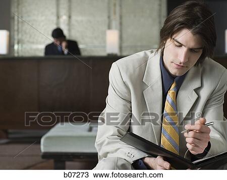 Man in hotel lobby View Large Photo Image Stock Image - Man in hotel lobby. Fotosearch