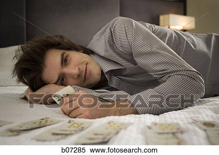 Man in hotel room playing solitaire View Large Photo Image Stock Photography - Man in hotel room playing solitaire. Fotosearch