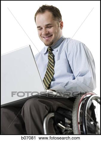 Man in wheelchair with laptop View Large Photo Image Stock Image - Man in wheelchair with laptop. Fotosearch