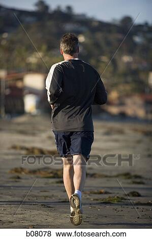 Man jogging on beach View Large Photo Image Stock Photo - Man jogging on beach. Fotosearch