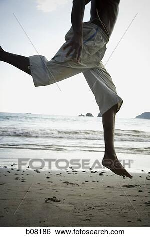 Man jumping on beach View Large Photo Image Stock Photograph - Man jumping on beach. Fotosearch