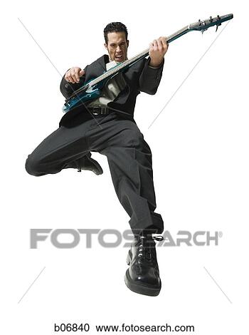 Stock Image - Man jumping with electric guitar. Fotosearch