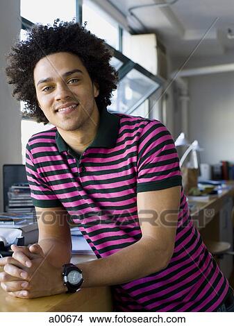 Man leaning on a work table View Large Photo Image Picture - Man leaning on a work table. Fotosearch