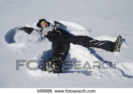 Man making snow angel View Large Photo Image Stock Photo - Man making snow angel. Fotosearch