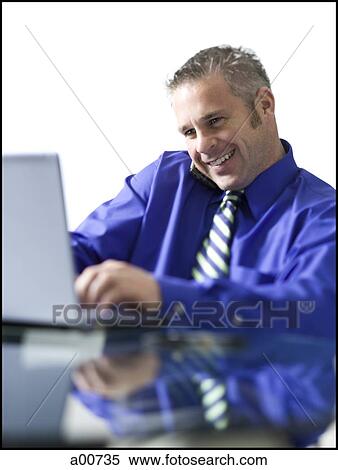 Man on a laptop View Large Photo Image Stock Photography - Man on a laptop. Fotosearch