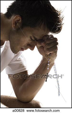 Stock Photo - Man praying. Fotosearch