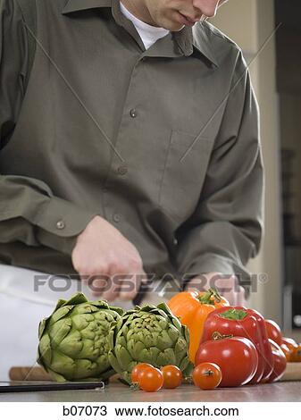 Man preparing vegetables View Large Photo Image Stock Image - Man preparing vegetables. Fotosearch