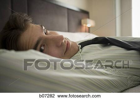 Man relaxing in hotel room View Large Photo Image Stock Image - Man relaxing in hotel room. Fotosearch