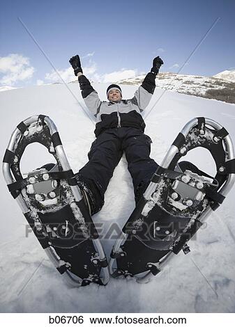 Man resting with snow shoes View Large Photo Image Stock Photograph - Man resting with snow shoes. Fotosearch