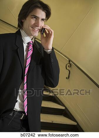 Man with bright necktie talking on cellphone View Large Photo Image Stock Image - Man with bright necktie talking on cellphone. Fotosearch