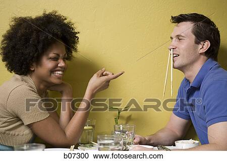 Man with chopsticks in nose at restaurant View Large Photo Image Stock Image - Man with chopsticks in nose at restaurant. Fotosearch