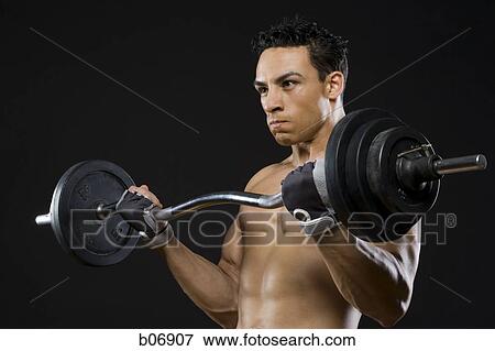 Man working out with barbell View Large Photo Image Stock Photo - Man working out with barbell. Fotosearch